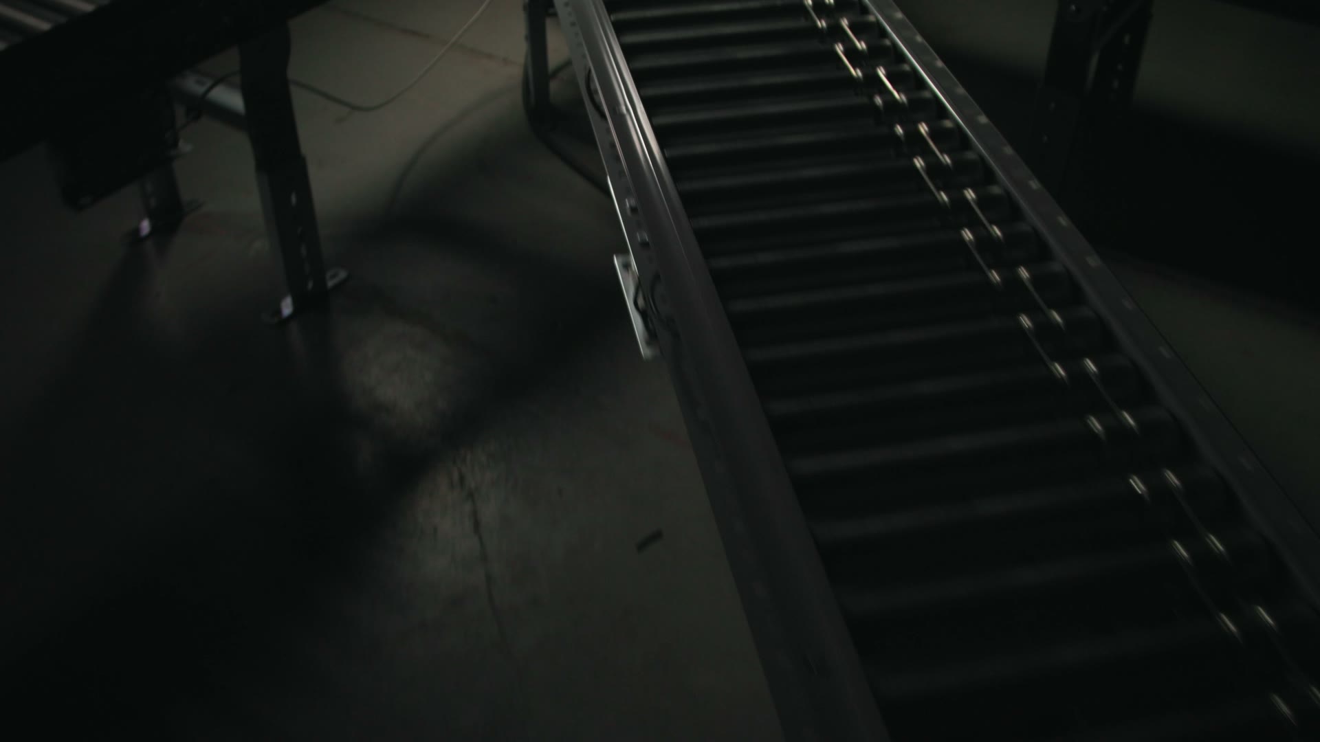 A powered-roller conveyor line in motion on the System Technology shop floor
